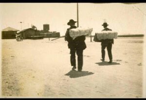 An old vintage photograph of two men walking