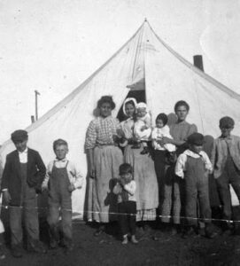 A group of people standing outside a tent