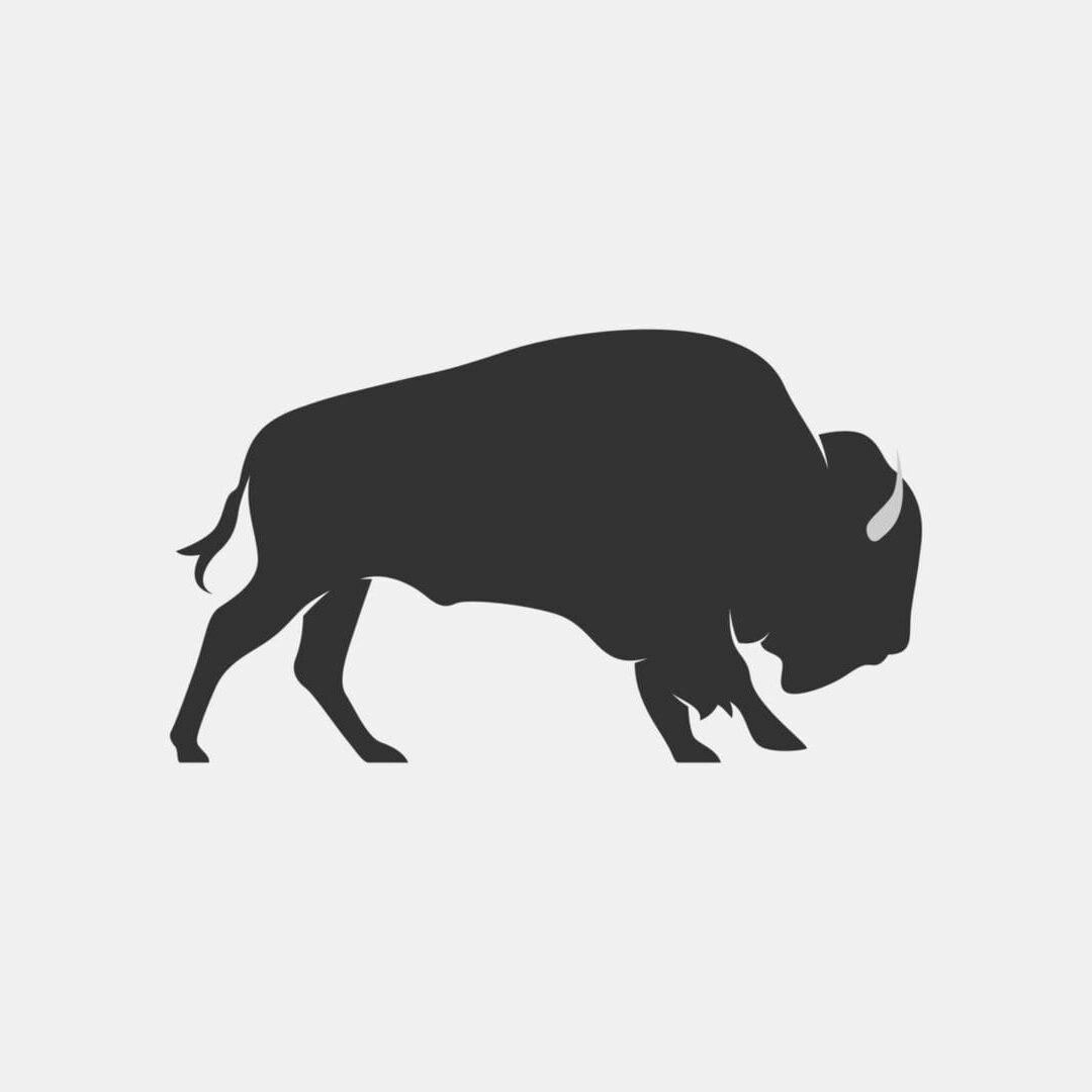 Silhouette of a grazing bison.